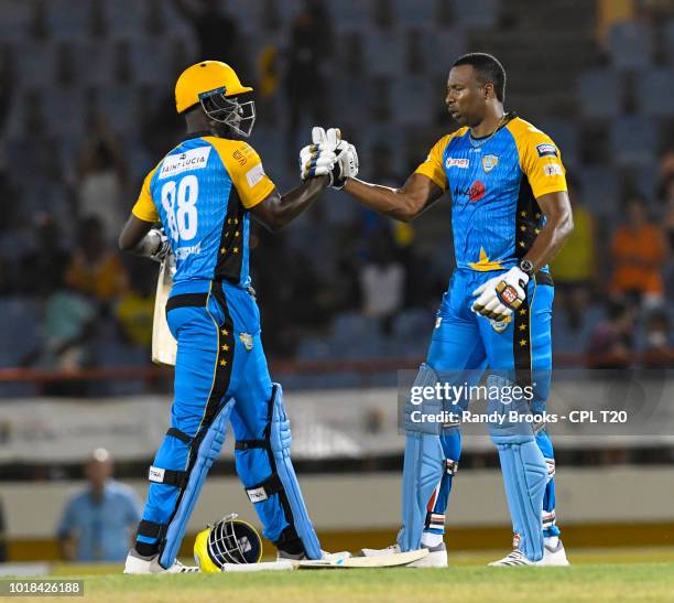 In this handout image provided by CPL T20, Darren Sammy and Kieron Pollard of St Lucia Stars during match 10 of the Hero Caribbean Premier League...
