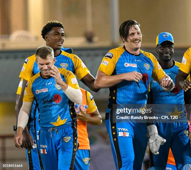 In this handout image provided by CPL T20, David Warner , Obed McCoy , Mitchell McClenaghan and Andre Fletcher of St Lucia Stars during match 10 of...