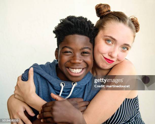 Young caucasian woman and african-american boy portrait.