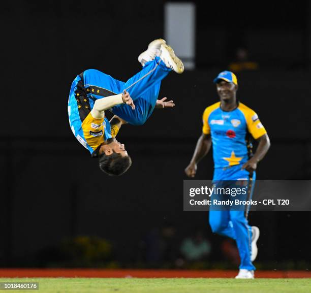 In this handout image provided by CPL T20, Darren Sammy watch as Qais Ahmad of St Lucia Stars celebrates the dismissal of Dwayne Smith of Barbados...