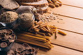 Wooden table full of fiber-rich wholegrain foods, perfect for a balanced diet