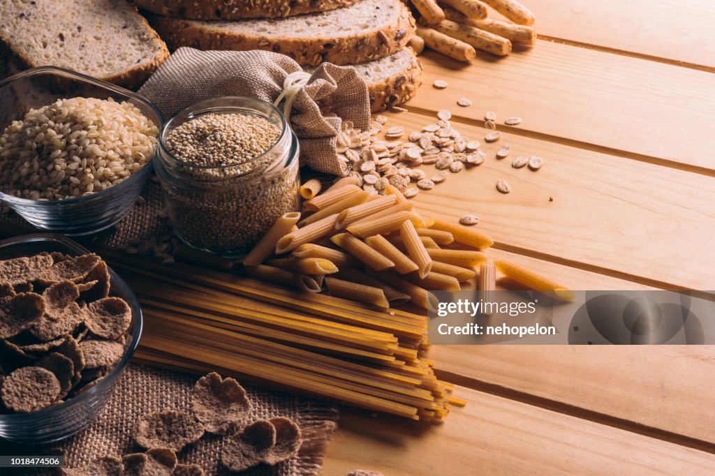 Wooden table full of fiber-rich wholegrain foods, perfect for a balanced diet