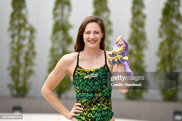 In this handout image provided by Swimming Australia, Cate Campbell poses with the five gold medals she won at the Pan Pacific Swimming Championships...