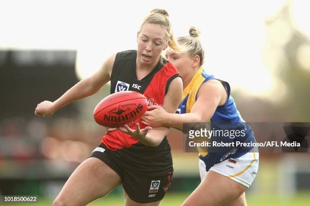 Molly Warburton of Essendon handballs during the VFLW round 15 match between Essendon and Williamstown at Windy Hill on August 18, 2018 in Melbourne,...
