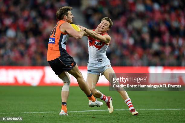 Jeremy Finlayson of the Giants is tackled by Will Hayward of the Swans during the round 22 AFL match between the Greater Western Sydney Giants and...