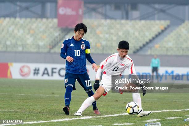 Koji Miyoshi of Japan in action against Kang II Kuk-Chol of North Korea during the AFC U23 Championship China 2018 Group B match between Japan and...