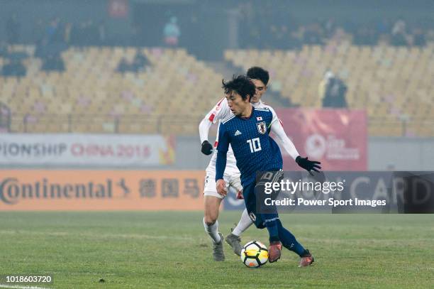 Koji Miyoshi of Japan in action against Ri Un-Chol of North Korea during the AFC U23 Championship China 2018 Group B match between Japan and North...