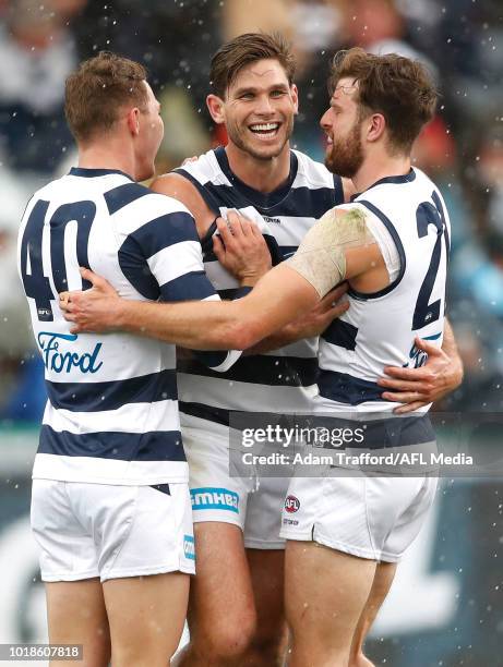 Tom Hawkins of the Cats celebrates a goal with Jackson Thurlow and Jordan Murdoch of the Cats during the 2018 AFL round 22 match between the Geelong...