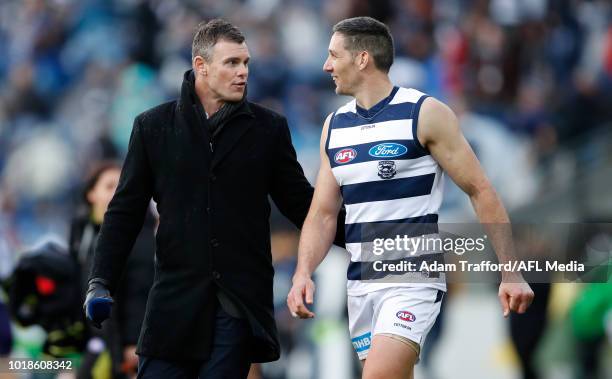Harry Taylor of the Cats chats to former Cats teammate Cameron Mooney during the 2018 AFL round 22 match between the Geelong Cats and the Fremantle...