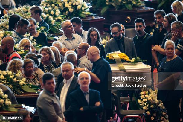 Mourners gather around the coffins during a State funeral service for the victims of the Morandi Bridge disaster at the Fiera di Genova exhibition...