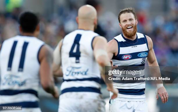 Lachie Henderson of the Cats congratulates Gary Ablett of the Cats on his 400th goal during the 2018 AFL round 22 match between the Geelong Cats and...