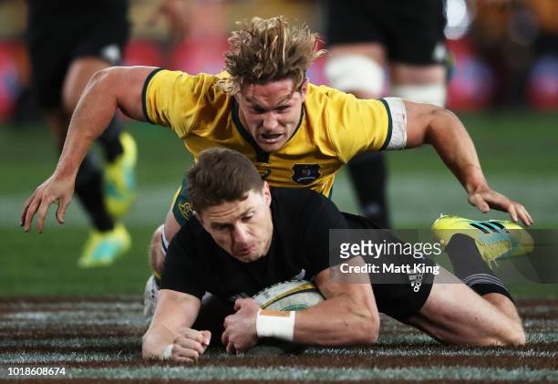 Beauden Barrett of the All Blacks is tackled by Michael Hooper of the Wallabies during The Rugby Championship Bledisloe Cup match between the...