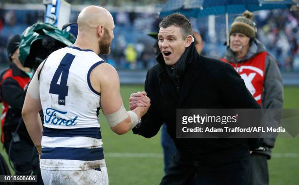 Gary Ablett of the Cats celebrates with former Cats teammate Cameron Mooney during the 2018 AFL round 22 match between the Geelong Cats and the...