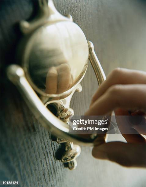 hand on door knocker - knocking stock pictures, royalty-free photos & images