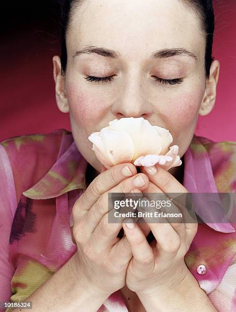 young woman smelling rose, close-up - lukta bildbanksfoton och bilder