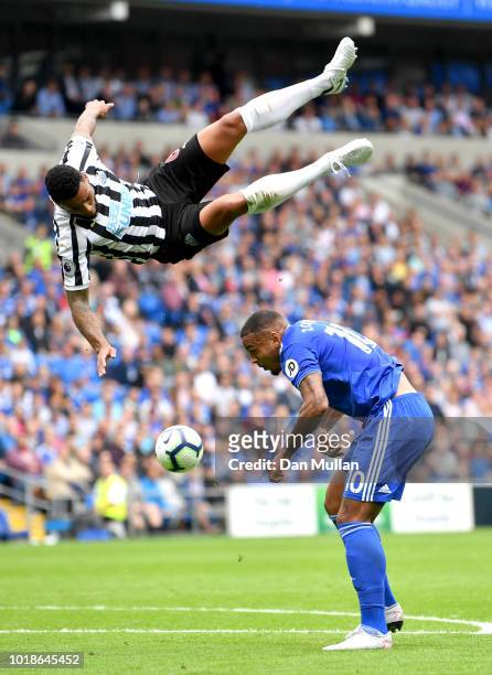 Jamaal Lascelles of Newcastle United challenges for the ball with Kenneth Zohore of Cardiff City during the Premier League match between Cardiff City...