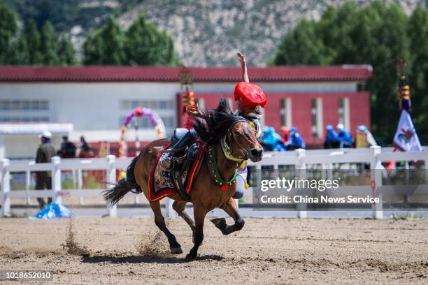An equestrian performs stunts during the Sho Dun Festival on August 13, 2018 in Lhasa, Tibet Autonomous Region of China. Equestrians performed over...