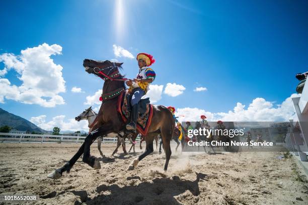 An equestrian performs stunts during the Sho Dun Festival on August 13, 2018 in Lhasa, Tibet Autonomous Region of China. Equestrians performed over...