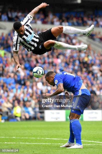 Jamaal Lascelles of Newcastle United challenges for the ball with Kenneth Zohore of Cardiff City during the Premier League match between Cardiff City...
