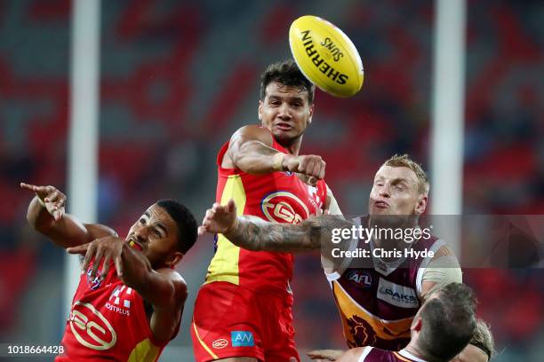 Callum Ah Chee of the Suns and Mitch Robinson of the Lions compete for the ball during the round 22 AFL match between the Gold Coast Suns and...