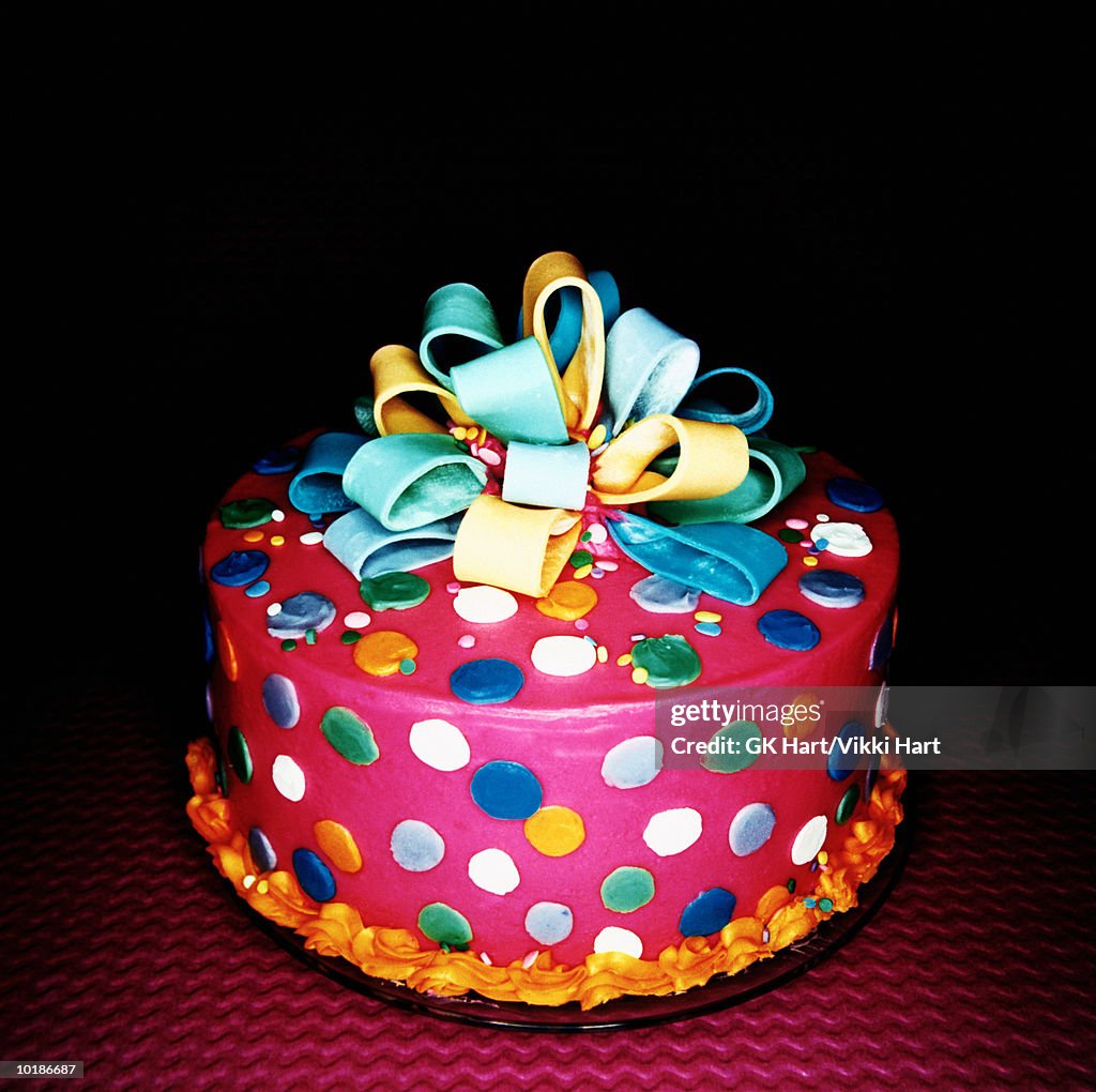 PINK FROSTED CAKE DECORATED WITH DOTS