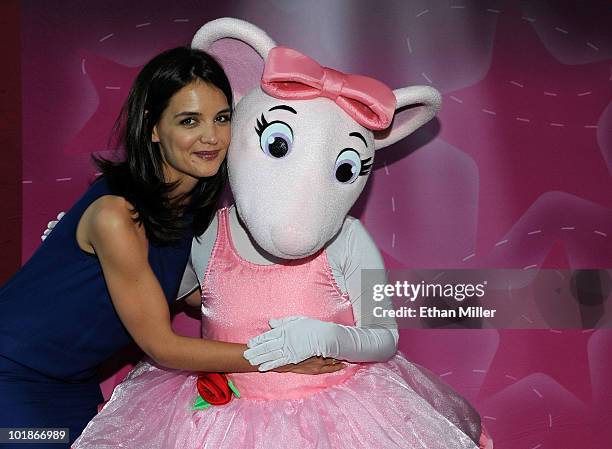 Actress Katie Holmes hugs an Angelina Ballerina costume character as she announces a partnership between her Dizzy Feet Foundation and Hit...