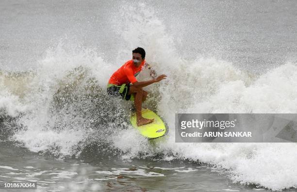 An Indian man surfs during the annual Covelong Point Classic Surf festival at Kovalam on the outskirts of Chennai on August 18, 2018.