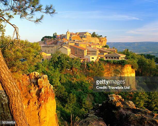france, provence, roussillon, morning light on cliff top village - roussillon stock pictures, royalty-free photos & images