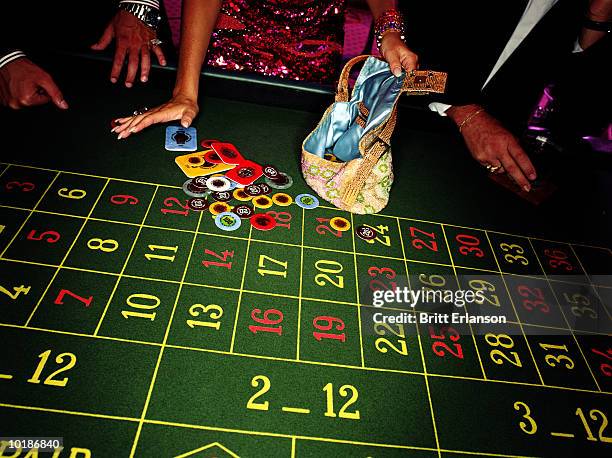 woman putting chips in handbag at roulette table, close-up - roleta, jogos - fotografias e filmes do acervo