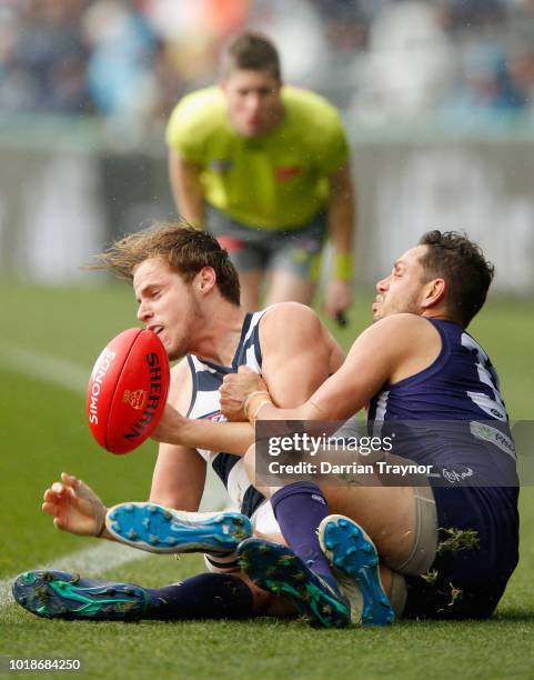 Michael Johnson of the Dockers tackles Jake Kolodjashnij of the Cats during the round 22 AFL match between the Geelong Cats and the Fremantle Dockers...