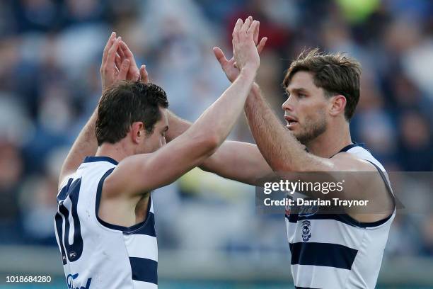 Daniel Menzel and Tom Hawkins of the Cats celebrate a goal during the round 22 AFL match between the Geelong Cats and the Fremantle Dockers at GMHBA...