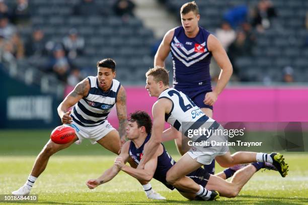 Lachie Neale of the Dockers handballs during the round 22 AFL match between the Geelong Cats and the Fremantle Dockers at GMHBA Stadium on August 18,...