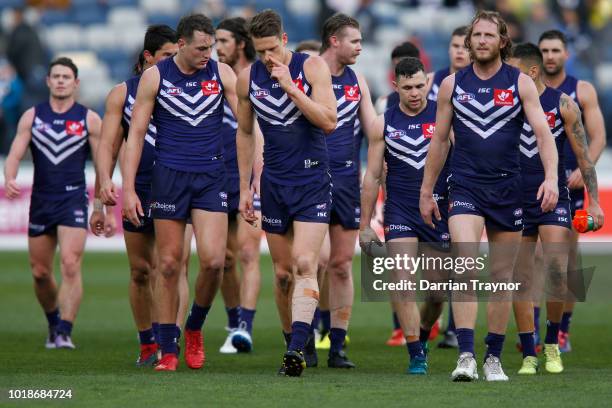 Fremantle players come off the ground after failing to kick a goal in the second quarter during the round 22 AFL match between the Geelong Cats and...