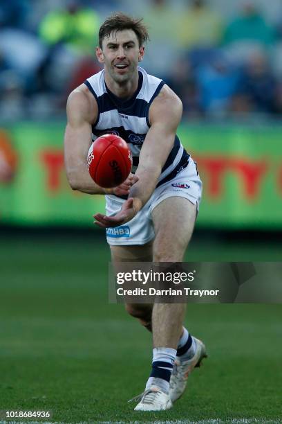 Ryan Abbott of the Cats handballs during the round 22 AFL match between the Geelong Cats and the Fremantle Dockers at GMHBA Stadium on August 18,...