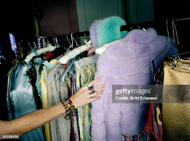 woman selecting clothes from rail, close-up - kleiderstange stock-fotos und bilder