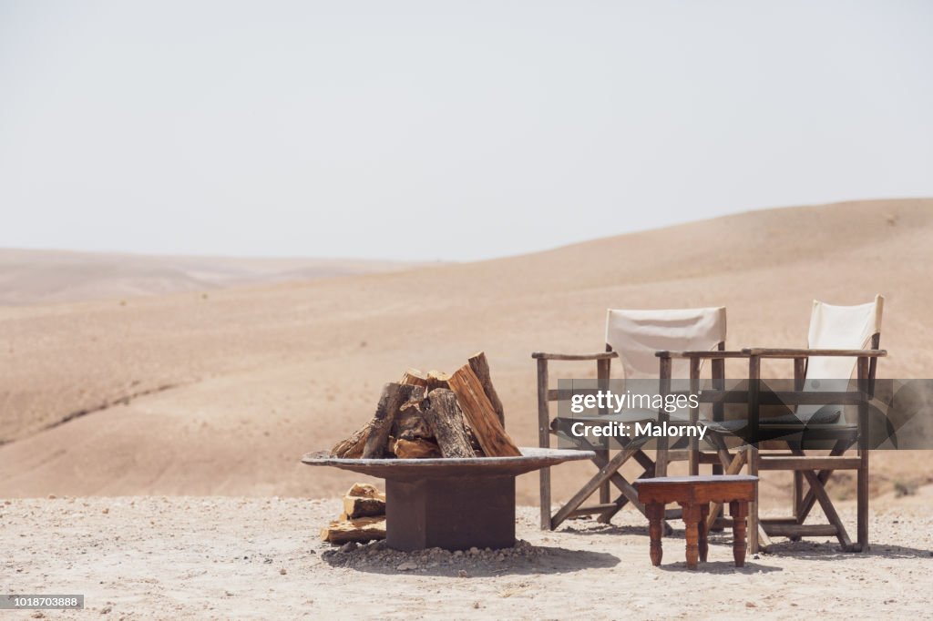 Chairs and a fire place at a tourist camp in moroccan desert. Marrakesh, Marrakesh-Safi, Morocco.