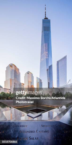 manhattan, lower manhattan, national september 11 memorial & museum, the south pool with the names of the victims, on the background some buildings with the one world trade center skyscraper - one world trade center stock pictures, royalty-free photos & images