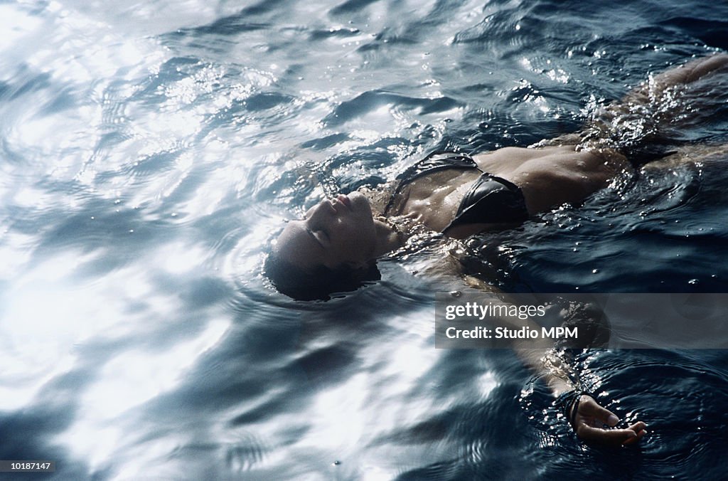 WOMAN FLOATING ON WATER