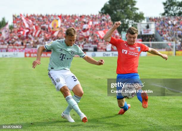 Joshua Kimmich of Muenchen is challenged by Jasper Goo§en of Drochtersen during the DFB Cup first round match between SV Drochtersen-Assel and Bayern...