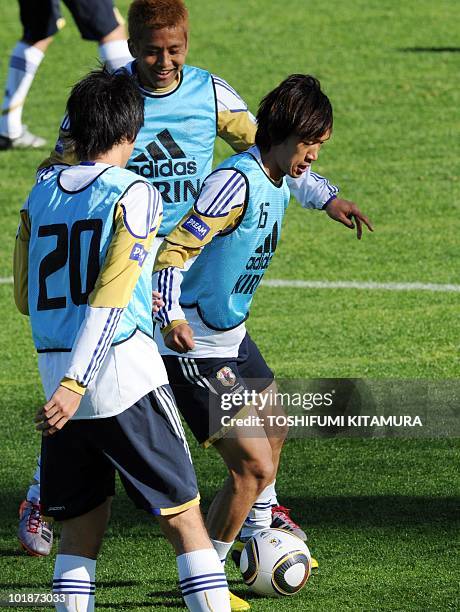 Japan's midfielder Shunsuke Nakamura dribbles the ball past Kazuya Yamamura and Junichi Inamoto during their training session at the Outeniqua...