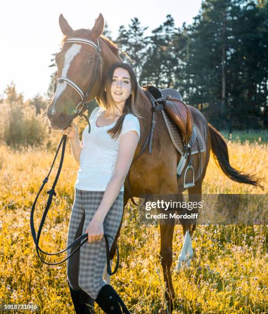 vacker kvinna med hennes häst promenader utomhus - dressage horse russia bildbanksfoton och bilder