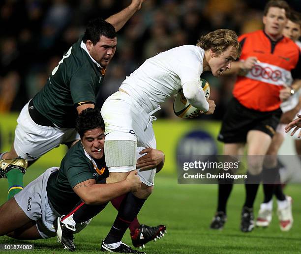 Mathew Tait of England is tackled by Pekahou Cowan and Laurie Weeks during the match between the Australian Barbarians and England at the Members...