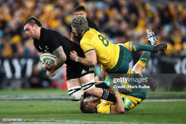 Liam Squire of the All Blacks is tackled by David Pocock and Bernard Foley of the Wallabies during The Rugby Championship Bledisloe Cup match between...