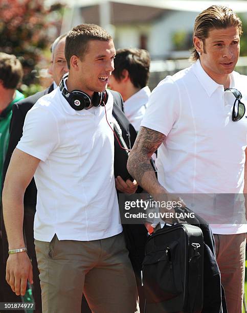 Germany's striker Lukas Podolski and goalkeeper Tim Wiese arrive at the team hotel Weineeg in Appiano, northern Italy, on May 21 where the German...