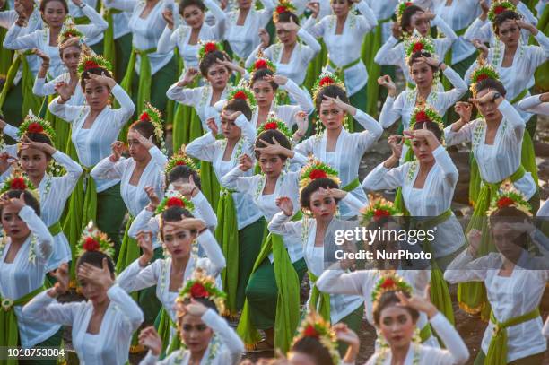 Young women perform the colossal dance Rejang Sandat Ratu Segara at Tanah Lot 2018 Festival on August 18, 2018 in Tabanan, Bali, Indonesia.