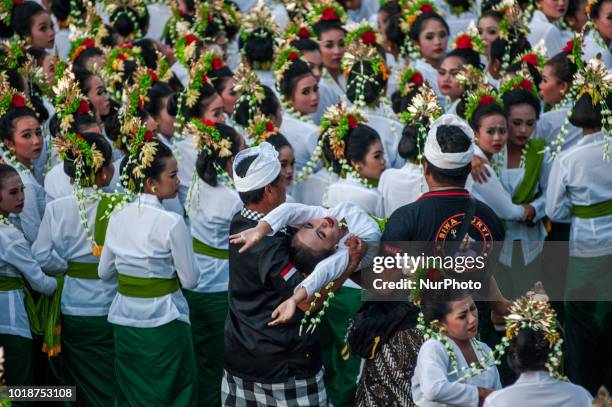 Woman trance after doing a colossal dance at Tanah Lot on August 18, 2018 in Tabanan, Bali, Indonesia. 1,800 young women perform the colossal dance...