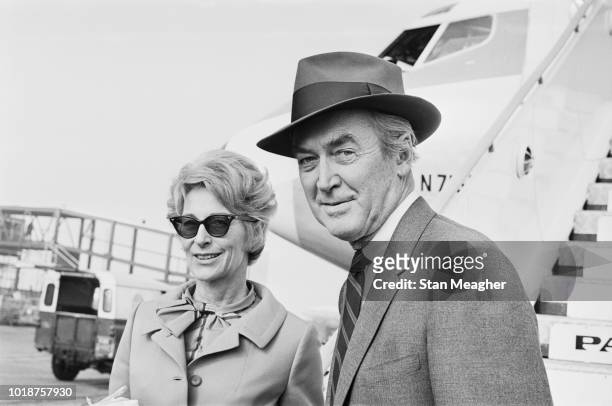 American actor and military officer James Stewart and Gloria Hatrick McLean at Heathrow Airport, London, UK, 13th October 1966.