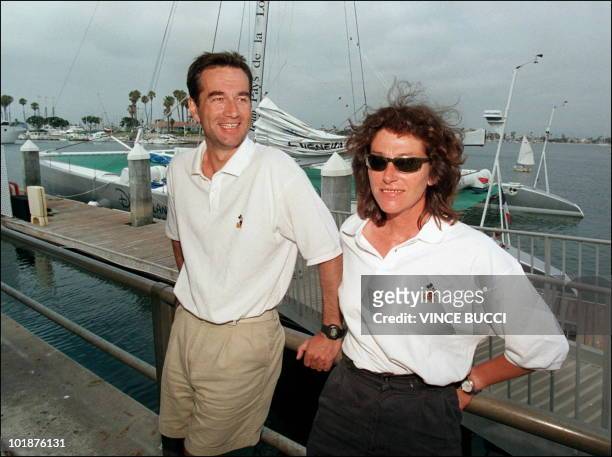French captain Bruno Peyron and crewmember Florence Arthaud wait near the catamaran "Explorer" in Long Beach prior to the start of the multihull...