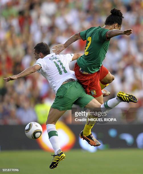 Cameroon´s defender Benoit Assou-Ekotto jumps for the ball with Portugal´s forward Simao Sabrosa during a World Cup friendly match against Cameroon...