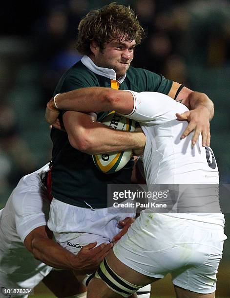 Ben McCalman of the Barbarians gets tackled by Dan Ward-Smith and Chris Robshaw of England during the match between the Australian Barbarians and...